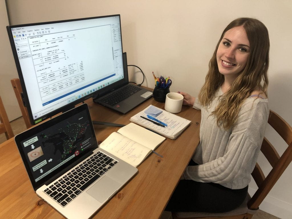 Photograph of Emily Robinson working at her computer.