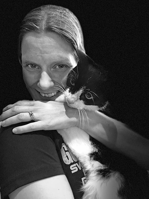 A headshot of Maureen Anderson holding a cat.