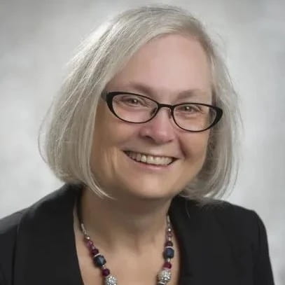 A headshot of Dr. Gisele Lapointe in front of a grey backdrop