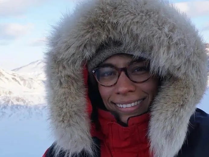 A headshot of Dr. Jackie Goordial in a snowy envronment wearing a hood