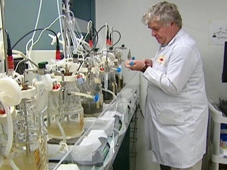 Dr. Mansel Griffiths working in a lab wearing a lab coat
