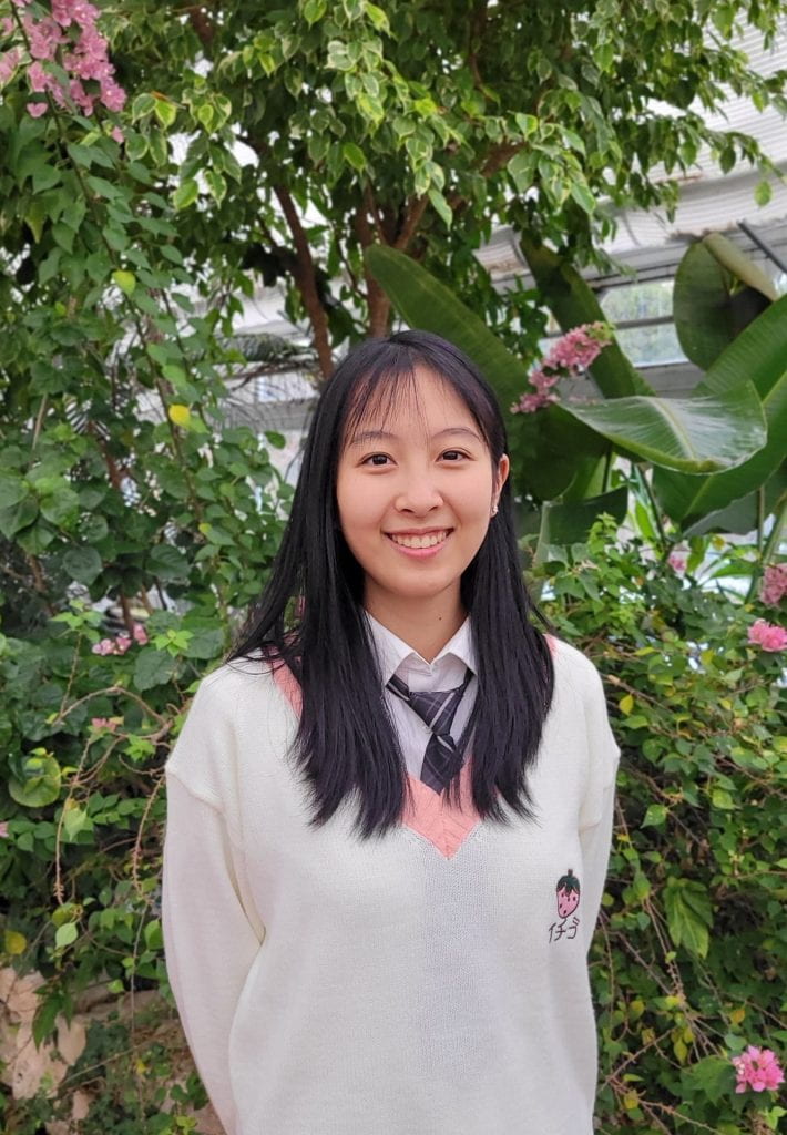 A photo of Yuqi (Angela) Hui in front of plants
